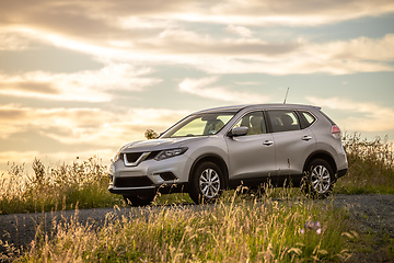 Image showing car in the sunset meadow