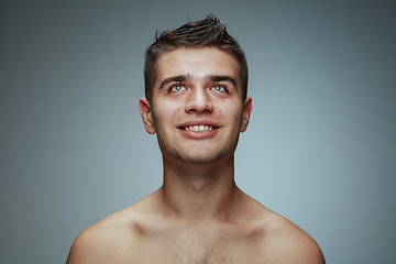 Image showing Portrait of shirtless young man isolated on grey studio background