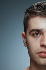 Image showing Close-up portrait of young man isolated on grey studio background