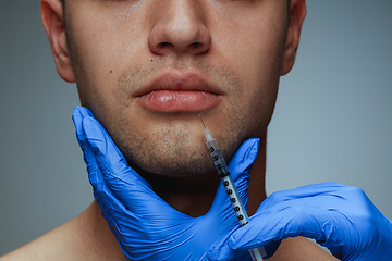 Image showing Close-up portrait of young man isolated on grey studio background