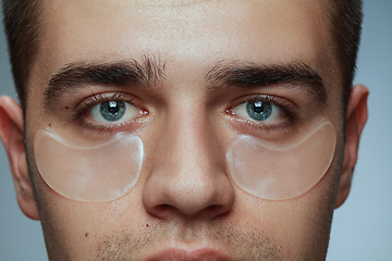 Image showing Close-up portrait of young man isolated on grey studio background