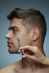 Image showing Close-up portrait of young man isolated on grey studio background