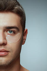 Image showing Close-up portrait of young man isolated on grey studio background