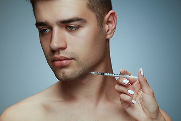 Image showing Close-up portrait of young man isolated on grey studio background