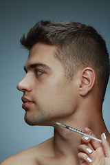 Image showing Close-up portrait of young man isolated on grey studio background