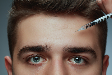 Image showing Close-up portrait of young man isolated on grey studio background