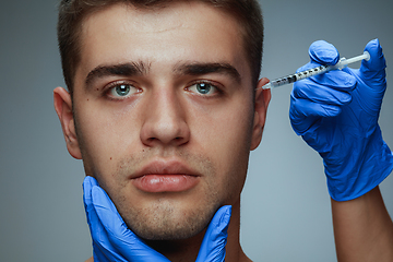 Image showing Close-up portrait of young man isolated on grey studio background