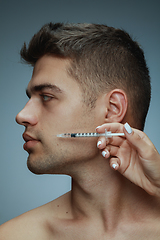 Image showing Close-up portrait of young man isolated on grey studio background