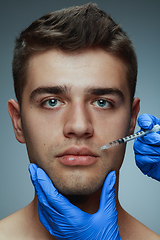 Image showing Close-up portrait of young man isolated on grey studio background