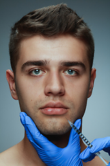 Image showing Close-up portrait of young man isolated on grey studio background