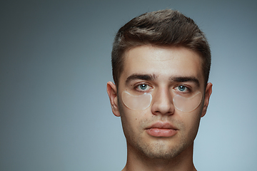 Image showing Close-up portrait of young man isolated on grey studio background