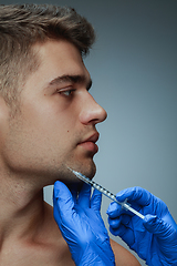 Image showing Close-up portrait of young man isolated on grey studio background