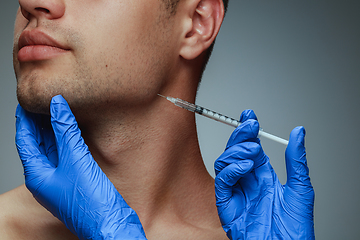 Image showing Close-up portrait of young man isolated on grey studio background