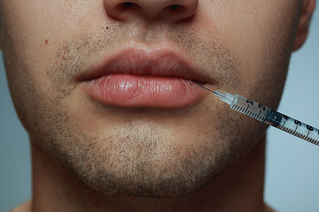 Image showing Close-up portrait of young man isolated on grey studio background