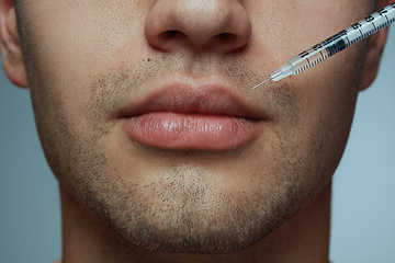 Image showing Close-up portrait of young man isolated on grey studio background