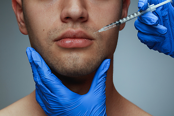 Image showing Close-up portrait of young man isolated on grey studio background