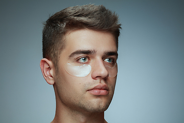 Image showing Close-up portrait of young man isolated on grey studio background