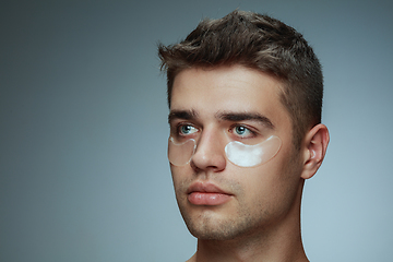 Image showing Close-up portrait of young man isolated on grey studio background