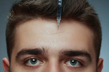 Image showing Close-up portrait of young man isolated on grey studio background