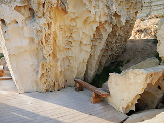 Image showing Wooden bench in the rocks.