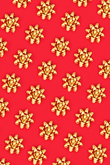 Image showing Christmas Gold Ribbon Bow Pattern on Red Background 