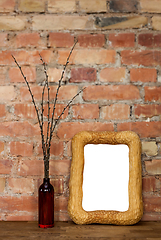 Image showing Photo frame and clay bottle with willow catkins