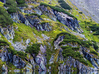 Image showing Mountain slope with small lake at botom