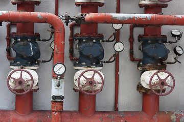 Image showing Red pipes with valves and manometers