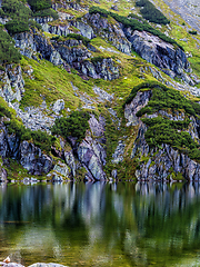 Image showing Mountain slope with small lake at botom