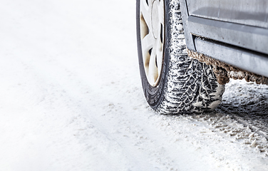 Image showing Winter Tyre on snowy country road.