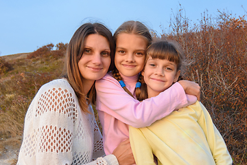 Image showing Portrait of a happy girl with two daughters on the background of nature