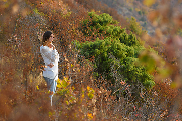 Image showing Girl walks in the forest on the mountainside
