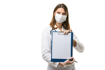 Image showing Girl doctor shows a tablet with a blank sheet of paper in front of her