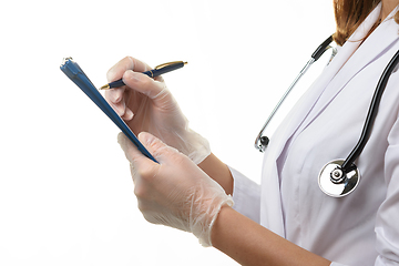 Image showing View of the hands of a doctor writing down a patient\'s diagnosis in a tablet