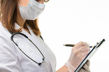 Image showing Doctor writes with a pen in a tablet computer on a sheet of paper, close-up