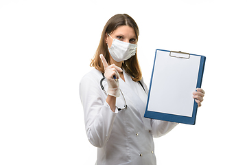 Image showing Girl doctor holds a tablet in her hands and shows a warning thumbs up