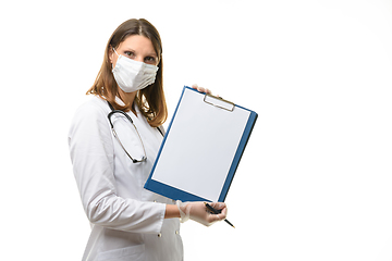 Image showing The doctor shows a tablet with a white sheet of paper in the frame