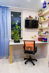 Image showing Writing desk in the children\'s room, view of the desk located by the window