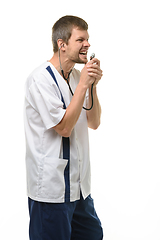 Image showing Irritated doctor yelling into stethoscope head isolated on white background