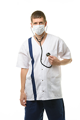 Image showing Tired doctor wearing mask listens to his heart with phonendoscope isolated on white background