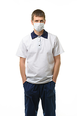 Image showing Masked doctor thrust his hands into pockets isolated on white