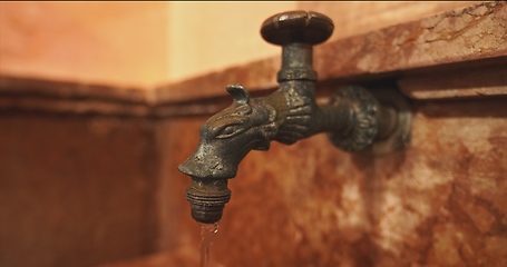 Image showing Old stone wash basin with decorative tap with water flowing