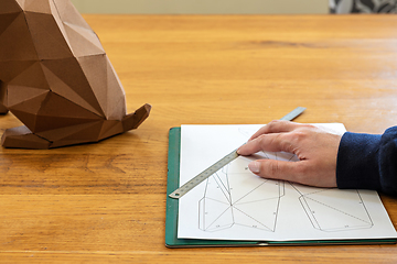 Image showing Somebody is making a cube sculpture with paper and linear