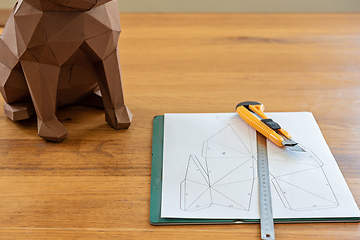 Image showing Paper, linear and knife on the table