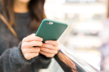 Image showing Woman sending sms on cellphone