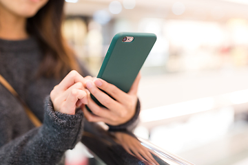 Image showing Woman sending sms on cellphone