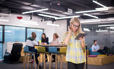 Image showing blonde businesswoman working online using digital tablet