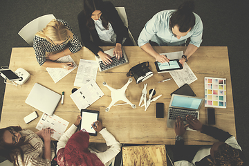 Image showing top view of multiethnic business team learning about drone techn