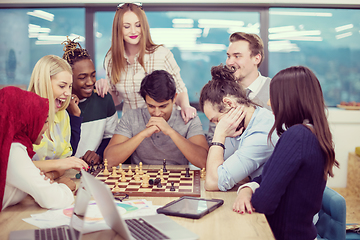 Image showing multiethnic group of business people playing chess