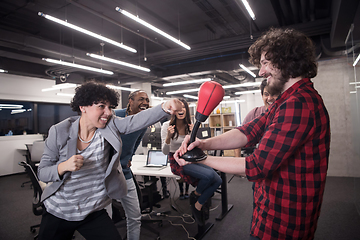 Image showing multiethnics business team boxing at office